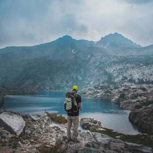 Beginner Backpacker In Front of Mountains