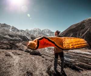 Man With Sleeping Bag in Mountains