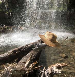 Woman's hiking hat on a rock